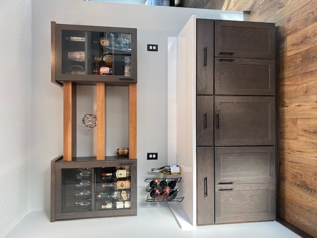 Kitchen - bar storage area with 3 contrasting wood shelves between the two upper cabinets and lower cabinets with white countertop