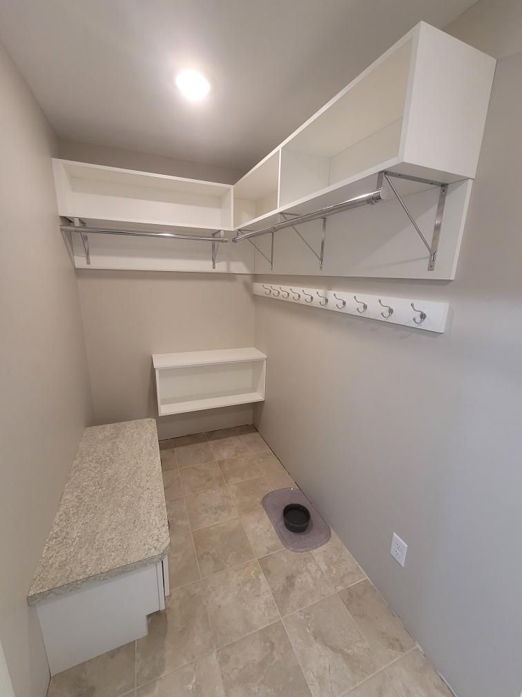 Custom entry way storage with hanging bars and hooks