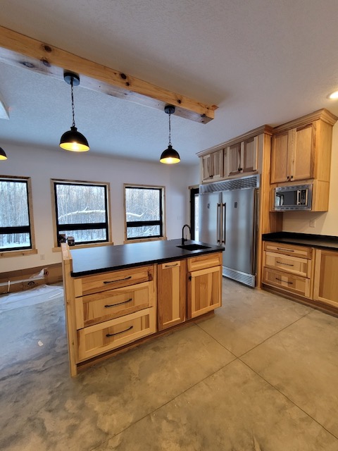 Kitchen cabinets with center island, black countertops